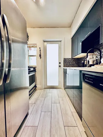 a kitchen with stainless steel appliances granite countertop a stove and a refrigerator
