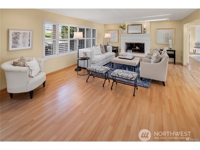 9631 Hilltop Road Bellevue, WA 98004 - Photo 4 of 17 a living room with furniture and a fireplace