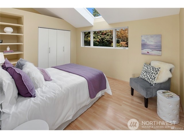 9631 Hilltop Road Bellevue, WA 98004 - Photo 9 of 17 a spacious bedroom with a bed and a window