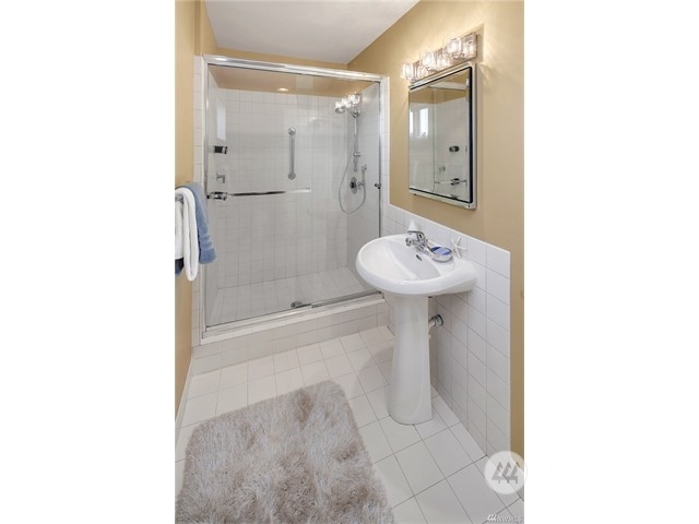 9631 Hilltop Road Bellevue, WA 98004 - Photo 10 of 17 a bathroom with a sink a toilet and shower