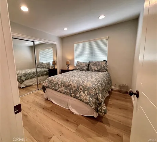 a bedroom with a bed and a large mirror