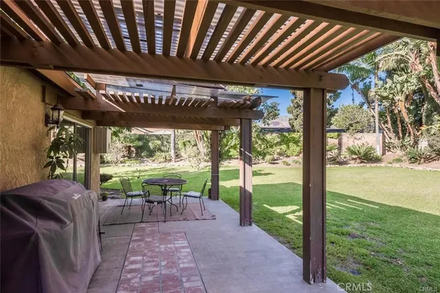 a view of a porch with furniture and a yard