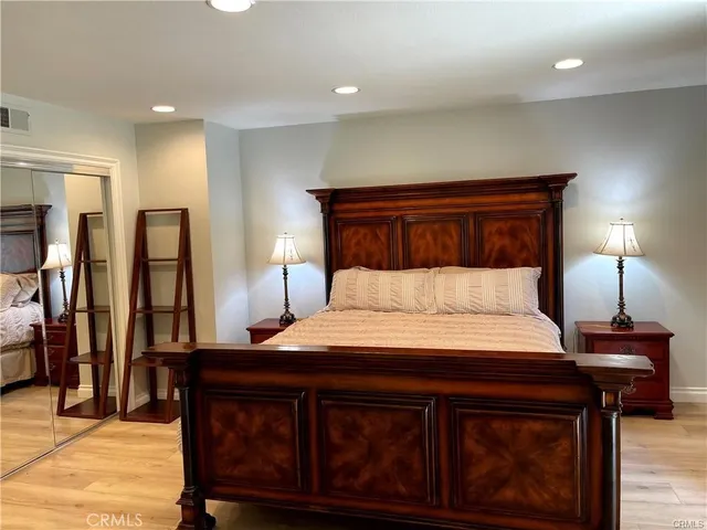 a bedroom with a bed and a night stand