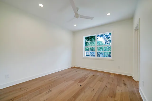 an aerial view of residential houses with outdoor space and trees