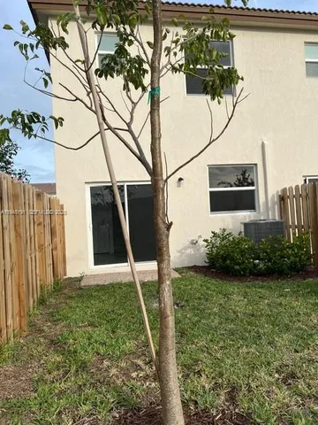 a view of a garden with wooden fence