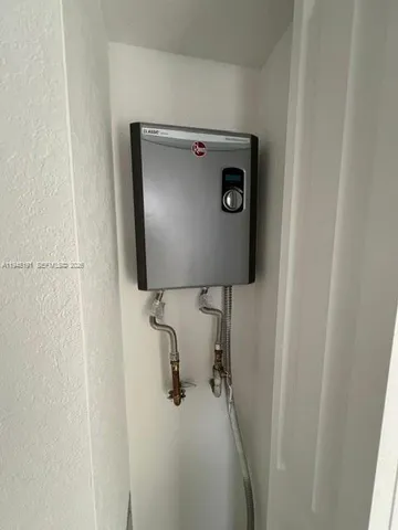 a kitchen with a sink a counter top space appliances and cabinets