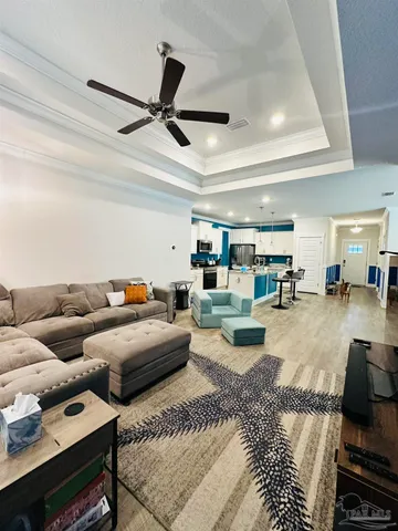 a living room with furniture and kitchen view