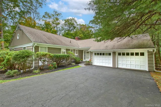 a front view of a house with a garden and porch