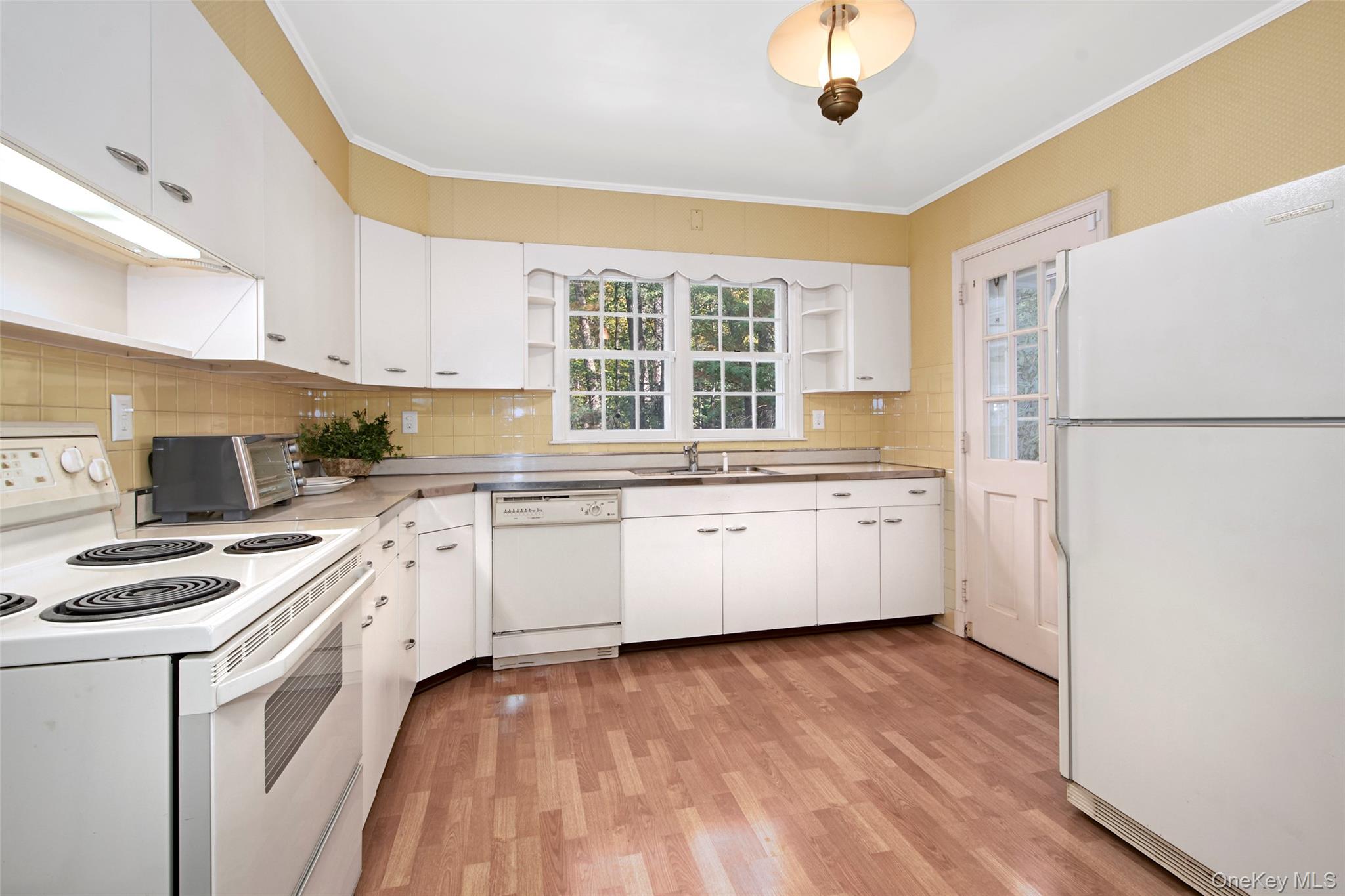 71 Commodore Road Chappaqua, NY 10514 - Photo 15 of 39 a kitchen with a white cabinets and white appliances
