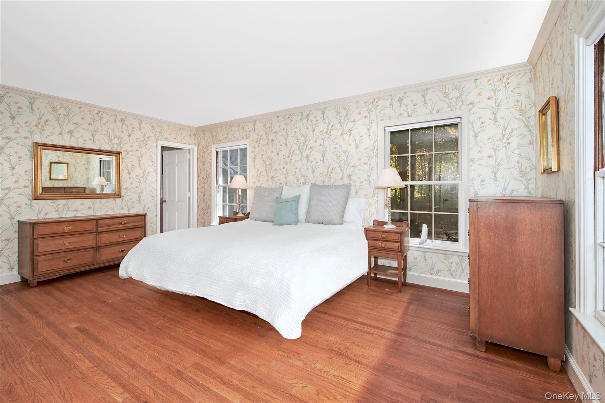 71 Commodore Road Chappaqua, NY 10514 - Photo 20 of 39 a bedroom with a bed and wooden floor
