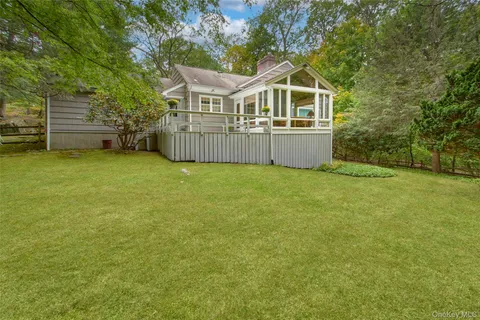 a front view of a house with a yard and fence