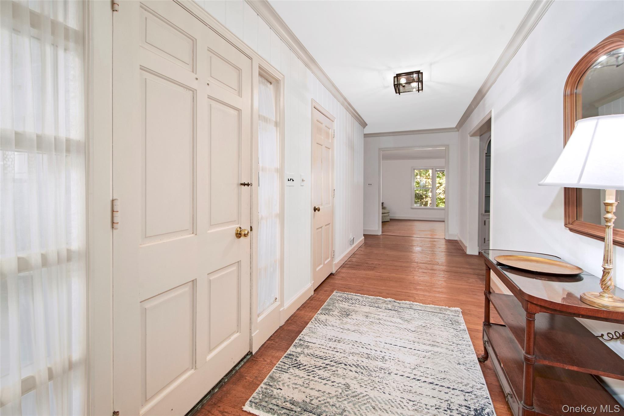 71 Commodore Road Chappaqua, NY 10514 - Photo 3 of 39 a view of a hallway with wooden floor and staircase