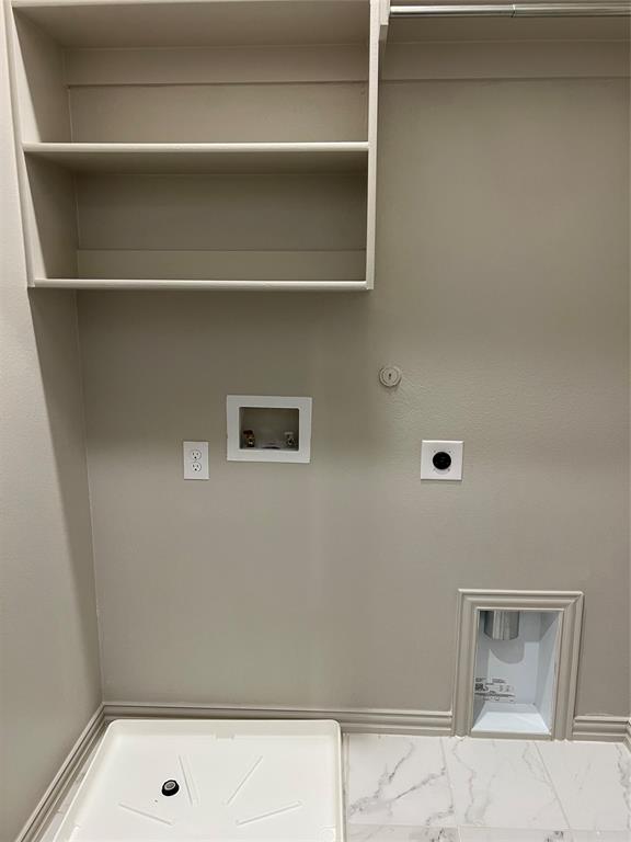 6041 Roper Road McKinney, TX 75070 - Photo 17 of 24 Laundry area featuring built-in shelving, a utility sink base, and marble-look flooring