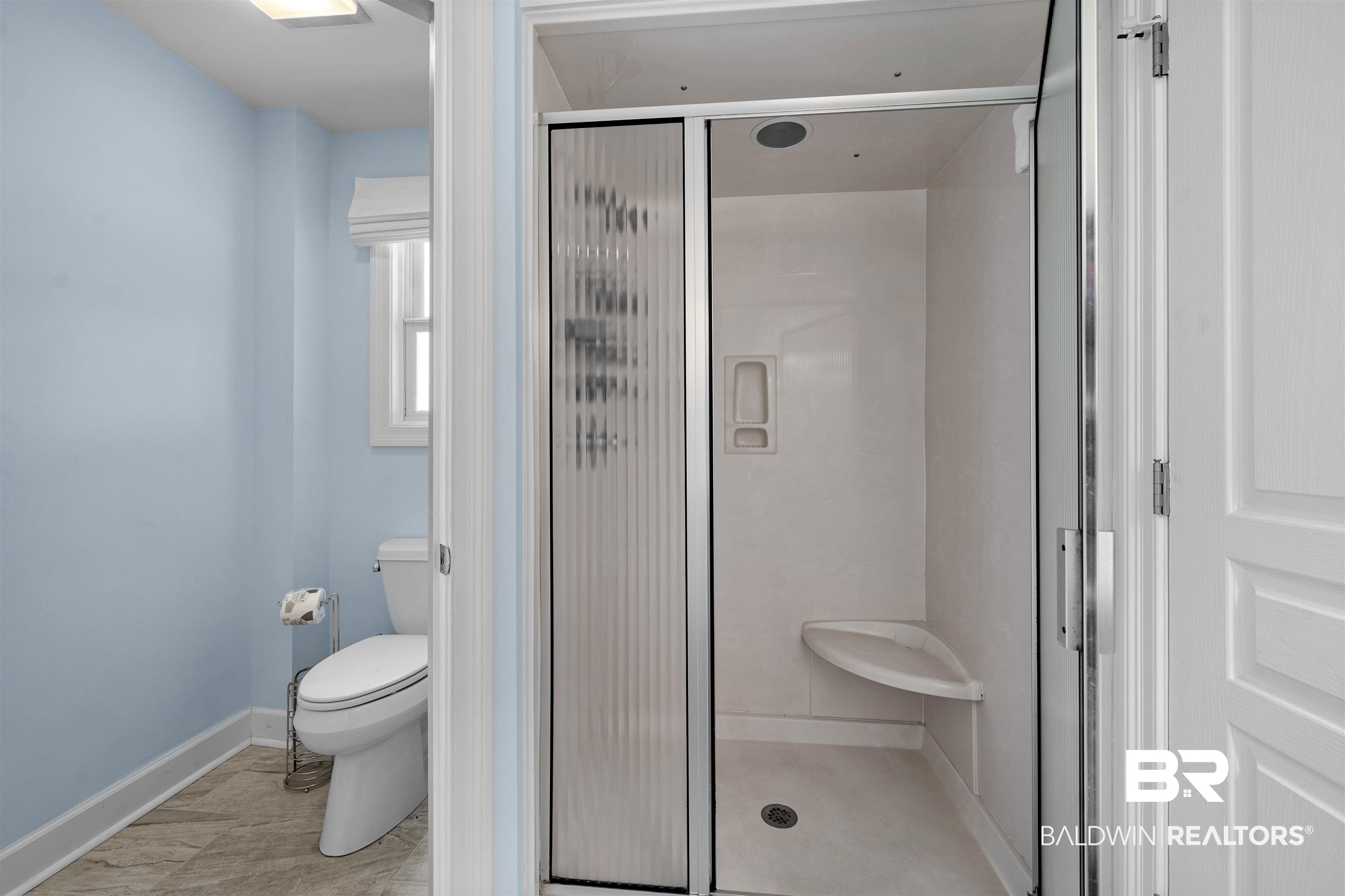 3434 Mariner Circle Orange Beach, AL 36561 - Photo 32 of 38 Bathroom with tile patterned floors, toilet, and an enclosed shower