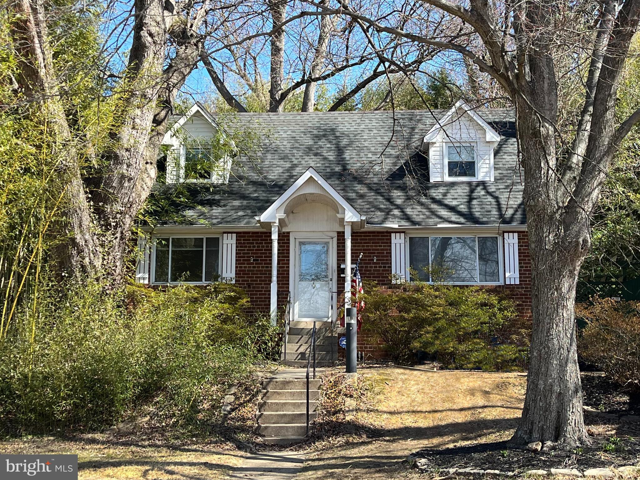 12811 Dean Road Silver Spring, MD 20906 - Photo 1 of 1 a front view of a house with trees
