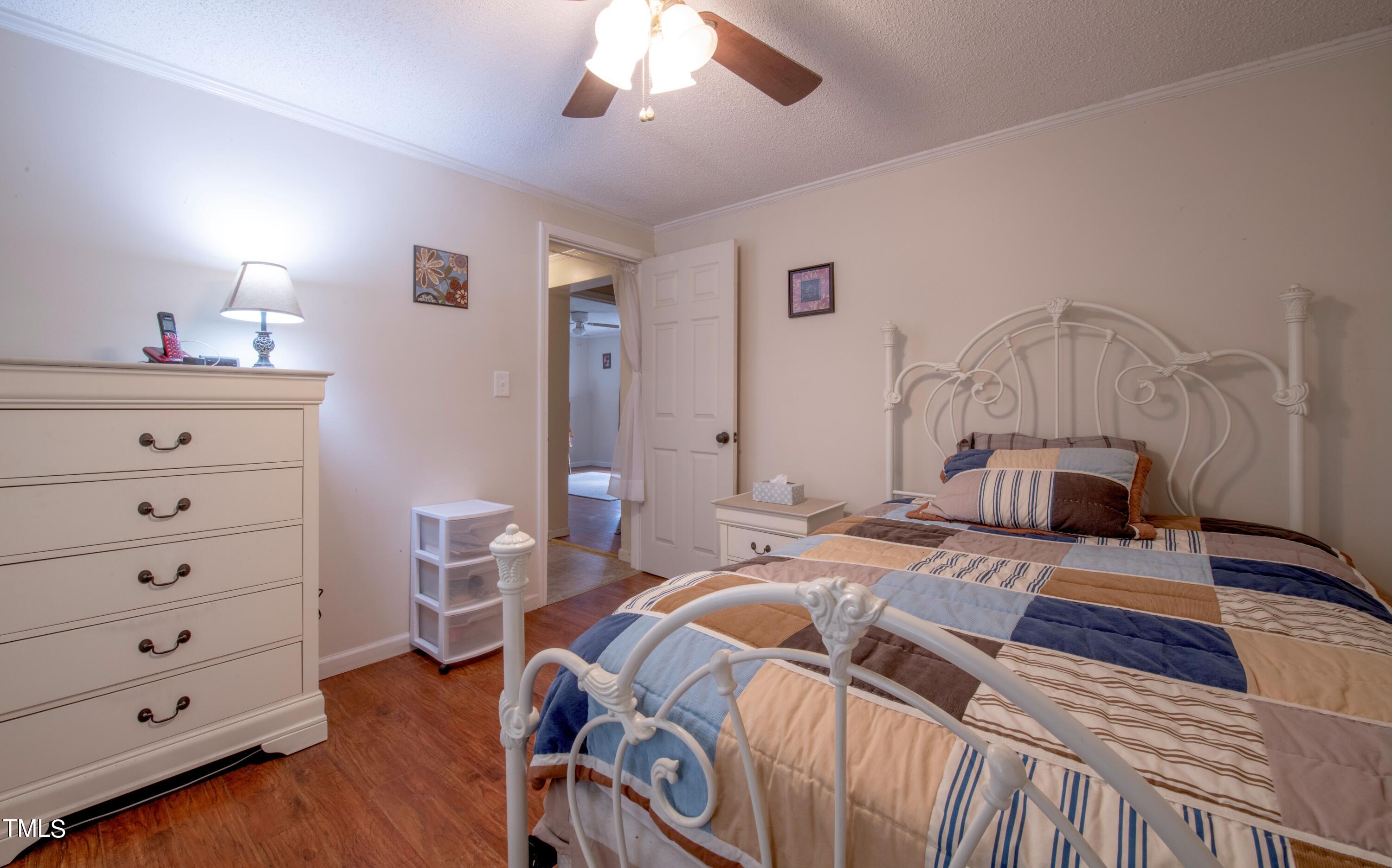 4180 Brantley Road Zebulon, NC 27597 - Photo 12 of 15 a bedroom with a bed and a dresser
