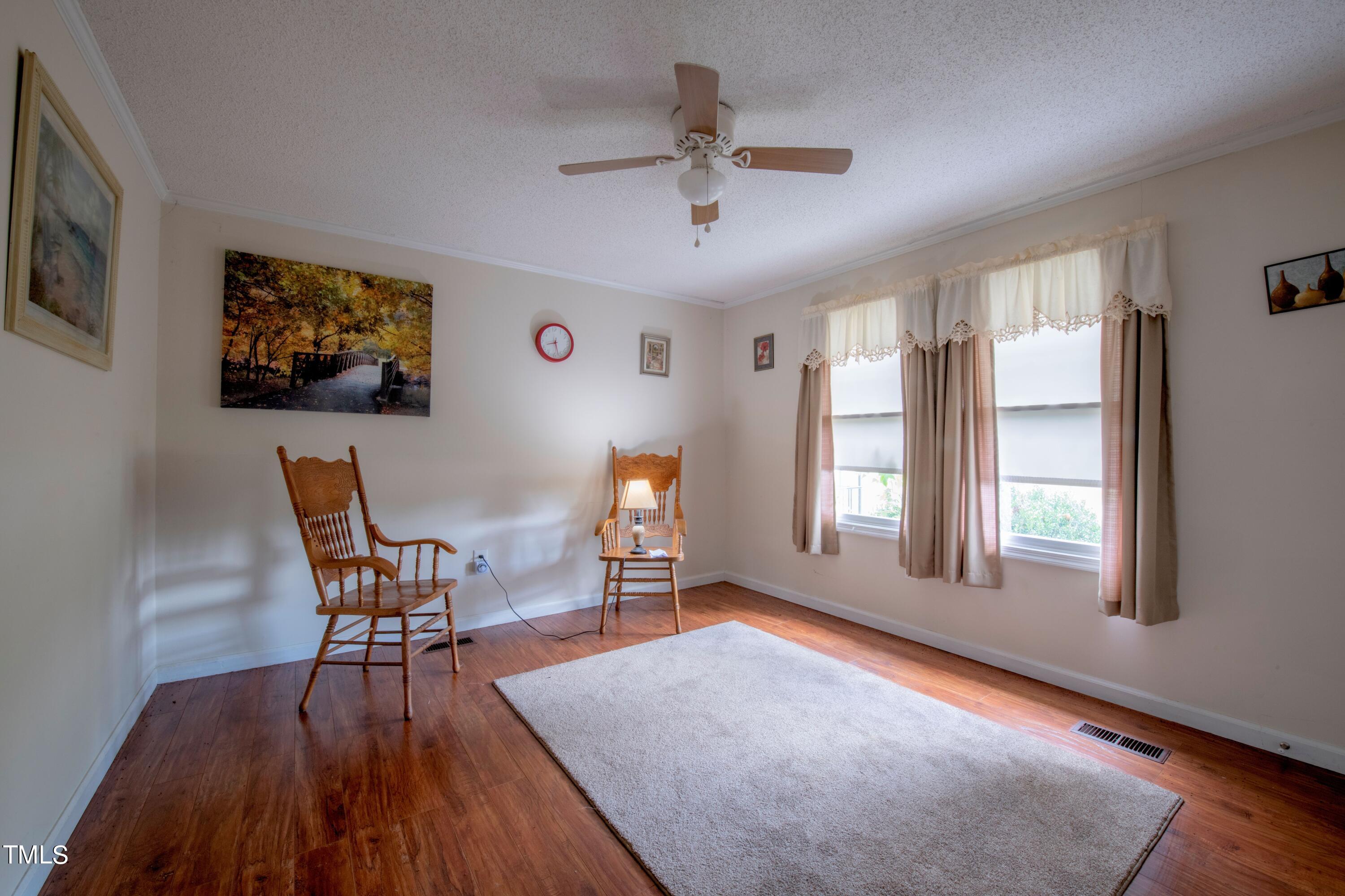 4180 Brantley Road Zebulon, NC 27597 - Photo 13 of 15 a workspace with furniture window and wooden floor