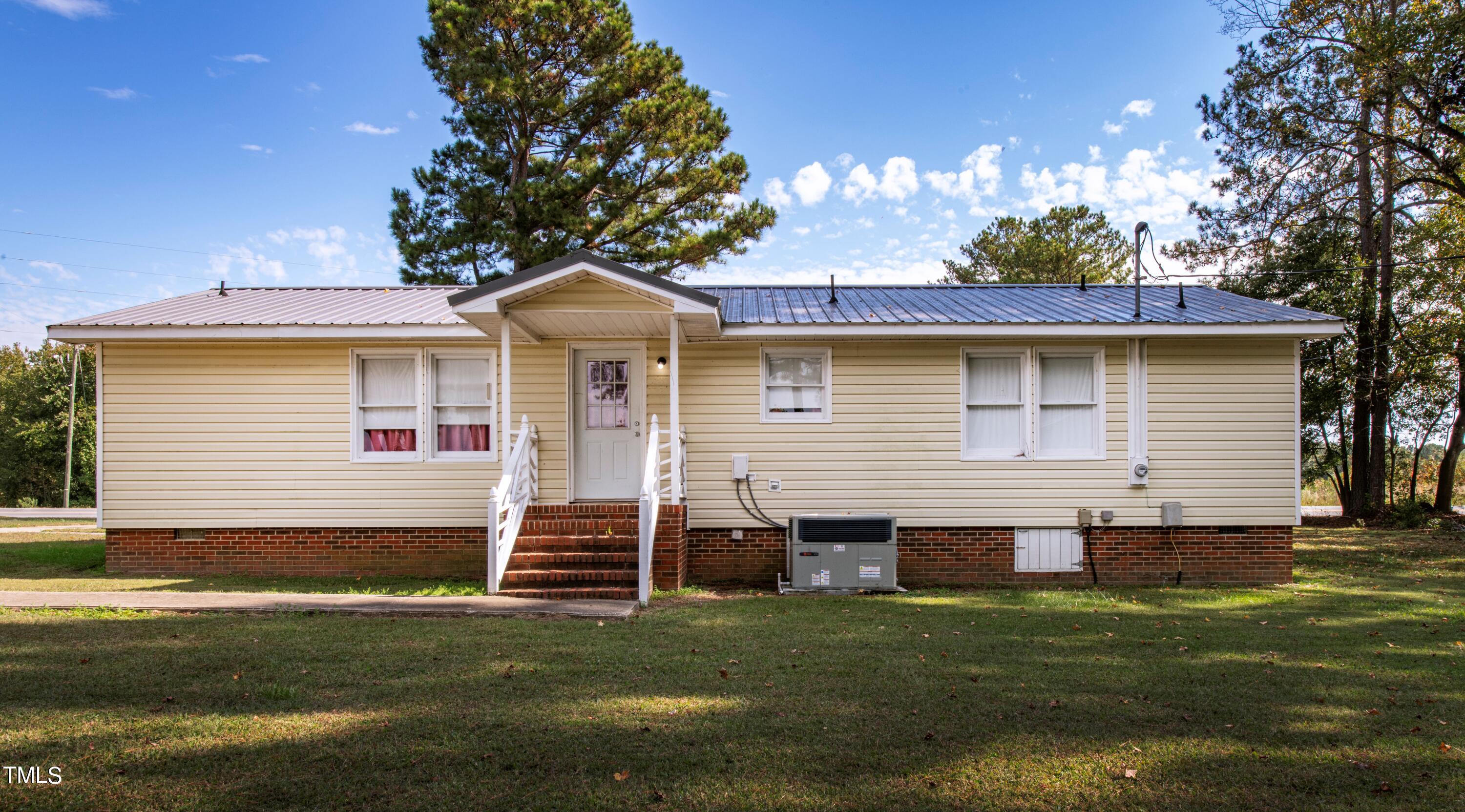 4180 Brantley Road Zebulon, NC 27597 - Photo 4 of 15 a front view of a house with a garden