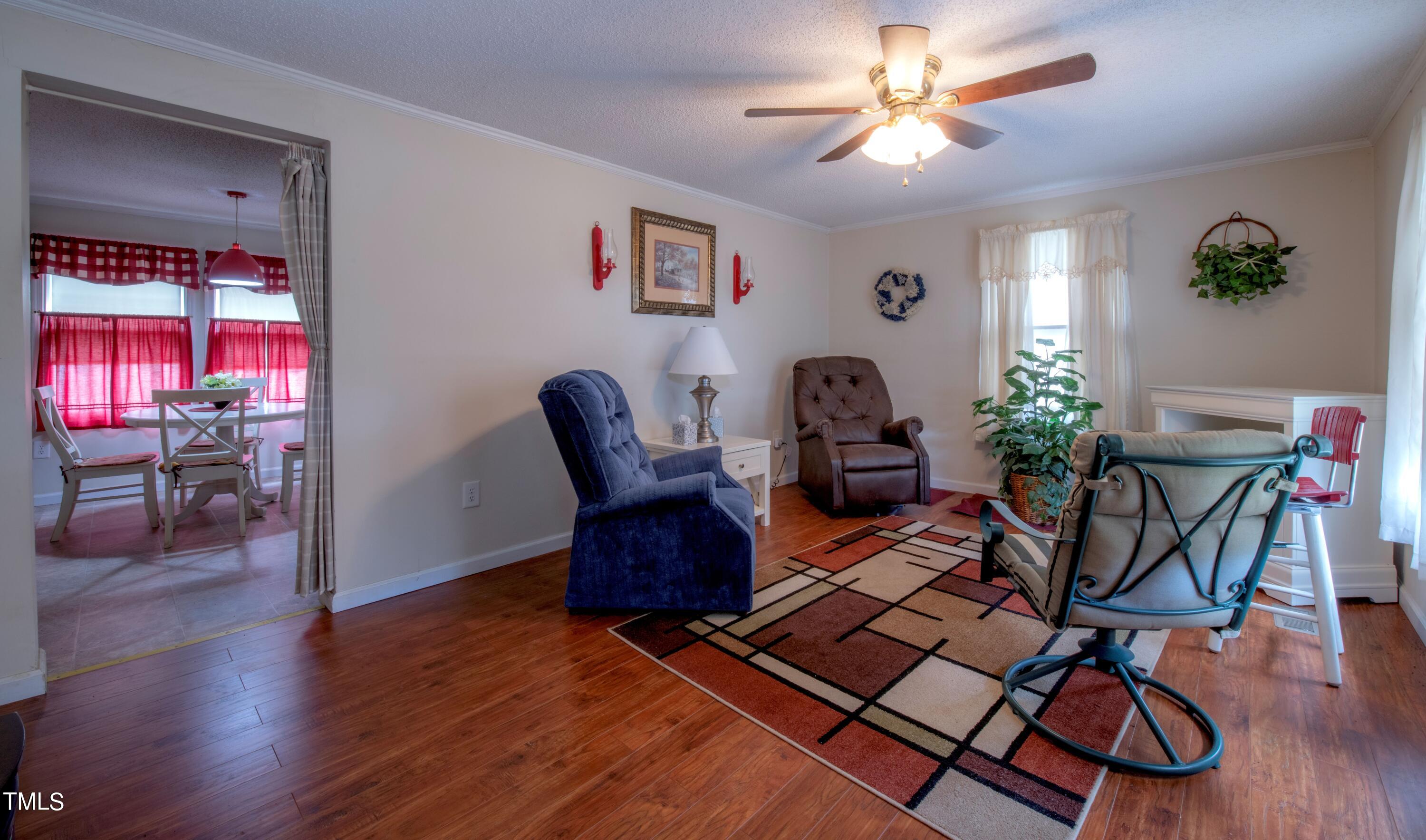 4180 Brantley Road Zebulon, NC 27597 - Photo 5 of 15 a living room with furniture rug and wooden floor