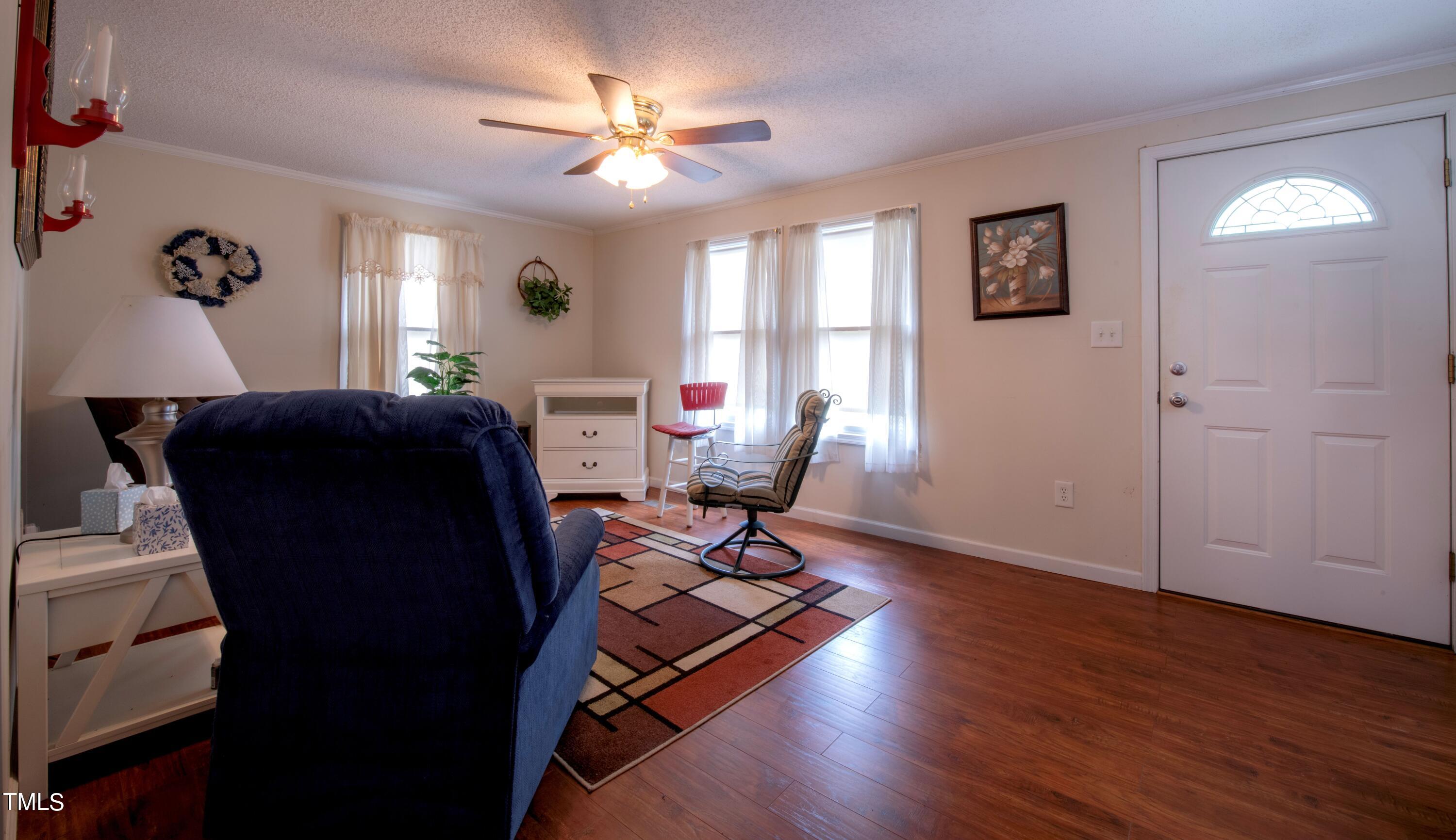 4180 Brantley Road Zebulon, NC 27597 - Photo 6 of 15 a living room with furniture and wooden floor