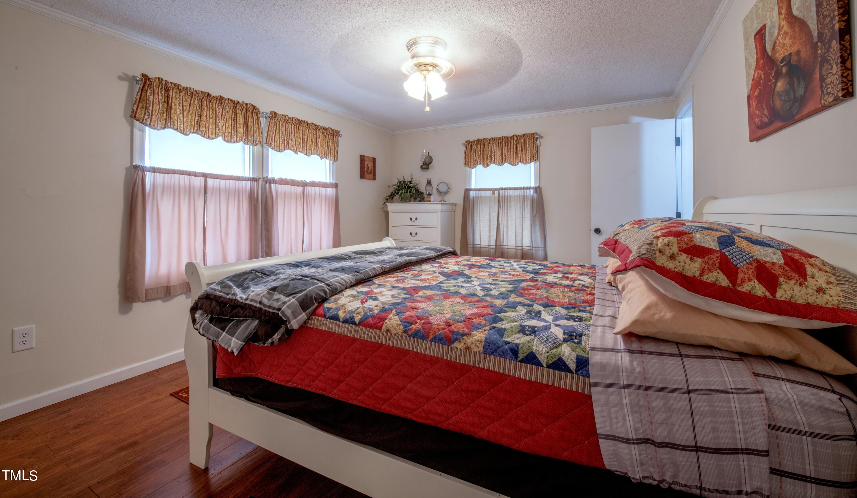 4180 Brantley Road Zebulon, NC 27597 - Photo 10 of 15 a bedroom with a bed and a window
