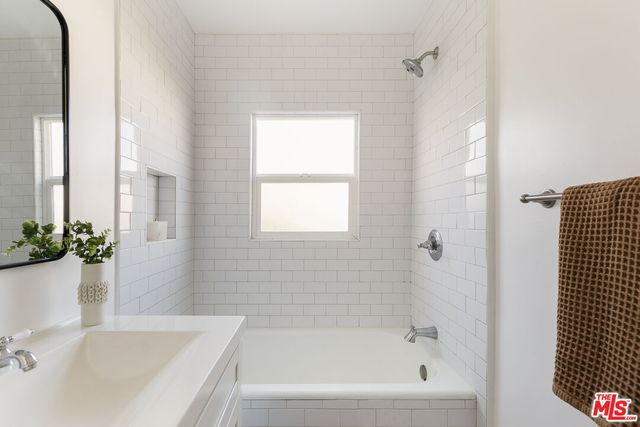 a bathroom with a tub and a sink