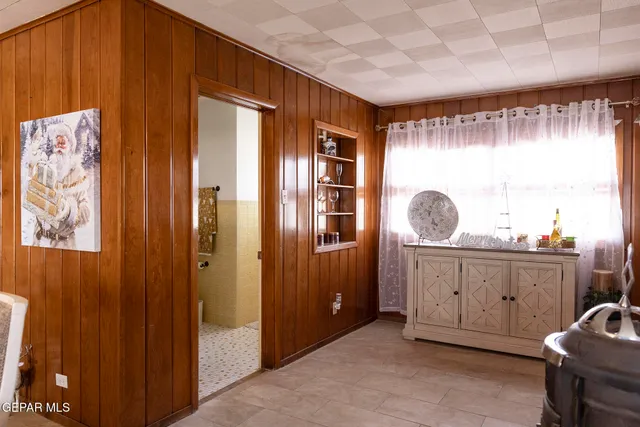 a view of a house with wooden deck and furniture