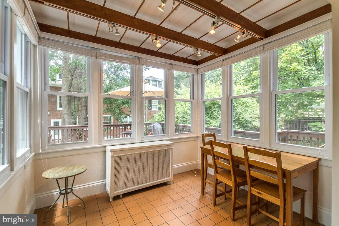 3924 Cloverhill Road Baltimore, MD 21218 - Photo 10 of 30 a view of a dining room with furniture large windows and wooden floor