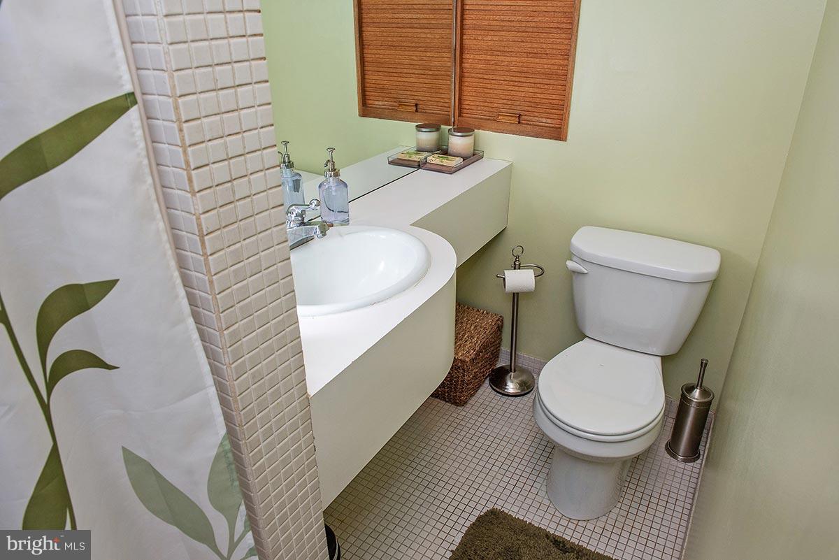 3924 Cloverhill Road Baltimore, MD 21218 - Photo 17 of 30 a bathroom with a toilet and a sink
