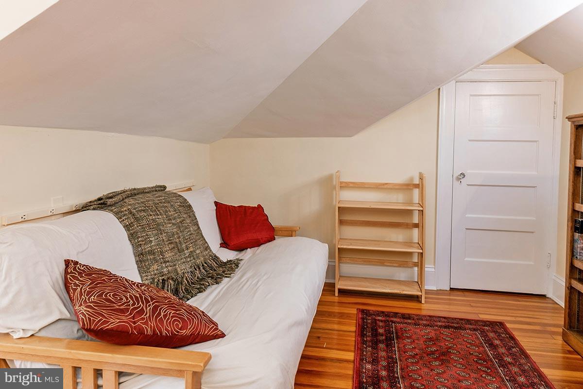 3924 Cloverhill Road Baltimore, MD 21218 - Photo 19 of 30 a bedroom with a bed and a chair