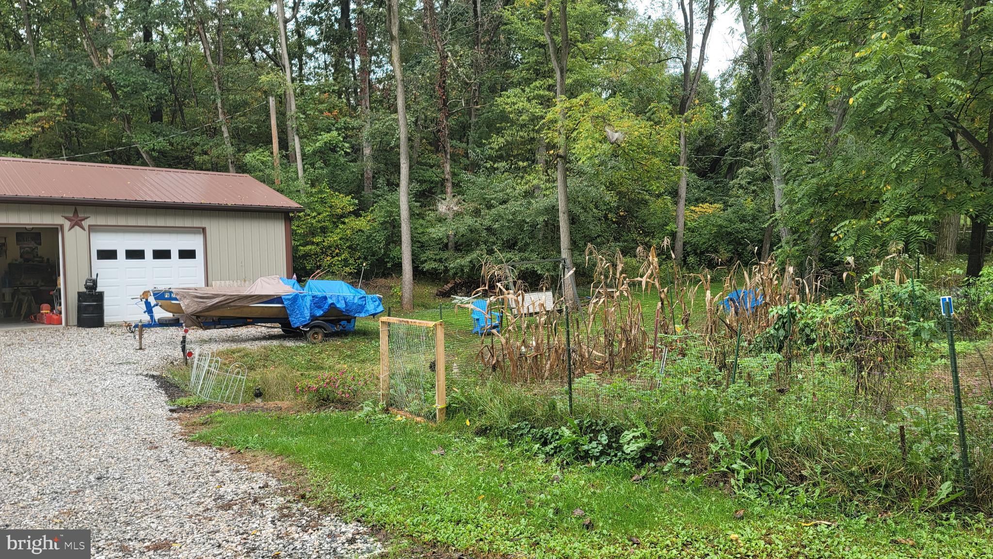 1711 Burkholder Road Red Lion, PA 17356 - Photo 2 of 24 a backyard of a house with barbeque oven table and chairs