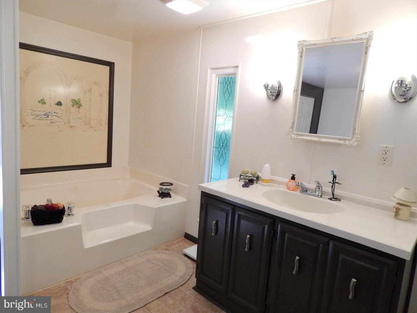 1711 Burkholder Road Red Lion, PA 17356 - Photo 17 of 24 a bathroom with a tub sink and mirror