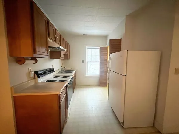 a kitchen with a refrigerator a stove top oven a sink and dishwasher
