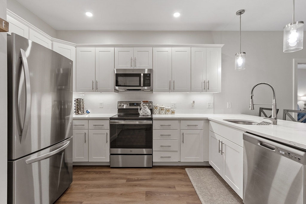 3202 Briarwood Village, Unit 3202 Clinton, MA 01510 - Photo 12 of 35 a kitchen with stainless steel appliances a refrigerator sink and cabinets