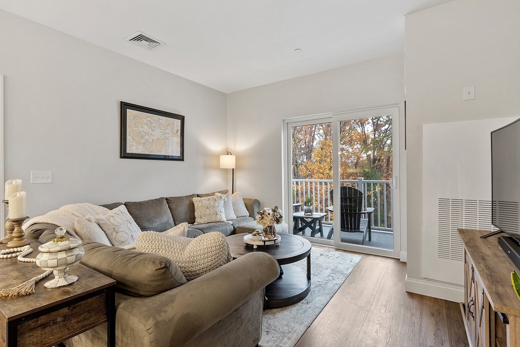 3202 Briarwood Village, Unit 3202 Clinton, MA 01510 - Photo 16 of 35 a living room with furniture and a large window
