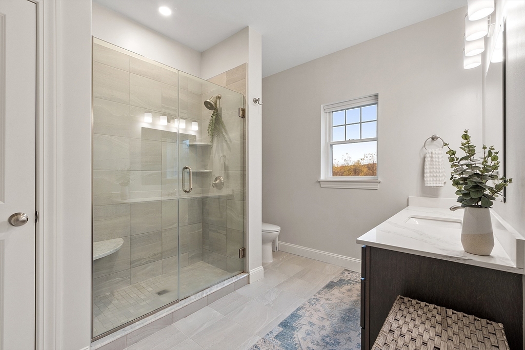3202 Briarwood Village, Unit 3202 Clinton, MA 01510 - Photo 25 of 35 a bathroom with a shower sink and mirror