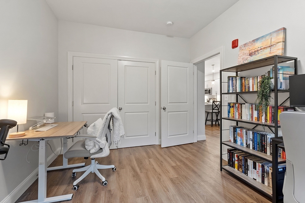 3202 Briarwood Village, Unit 3202 Clinton, MA 01510 - Photo 28 of 35 a view of a workspace with furniture and wooden floor
