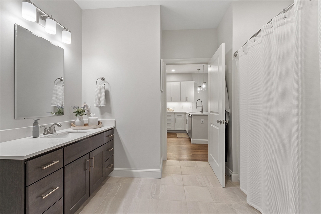 3202 Briarwood Village, Unit 3202 Clinton, MA 01510 - Photo 29 of 35 a bathroom with a double vanity sink mirror and shower