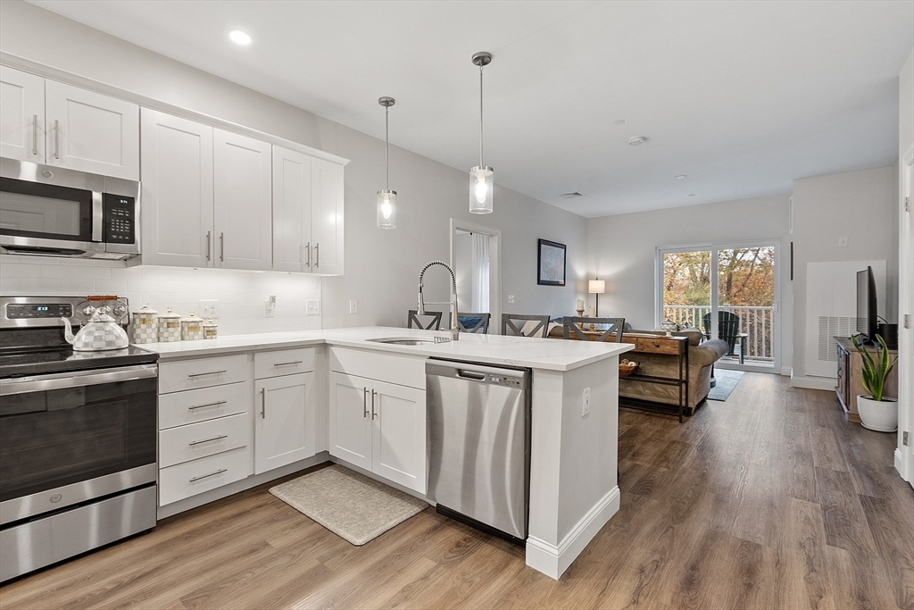 3202 Briarwood Village, Unit 3202 Clinton, MA 01510 - Photo 7 of 35 a kitchen with sink stove and cabinets