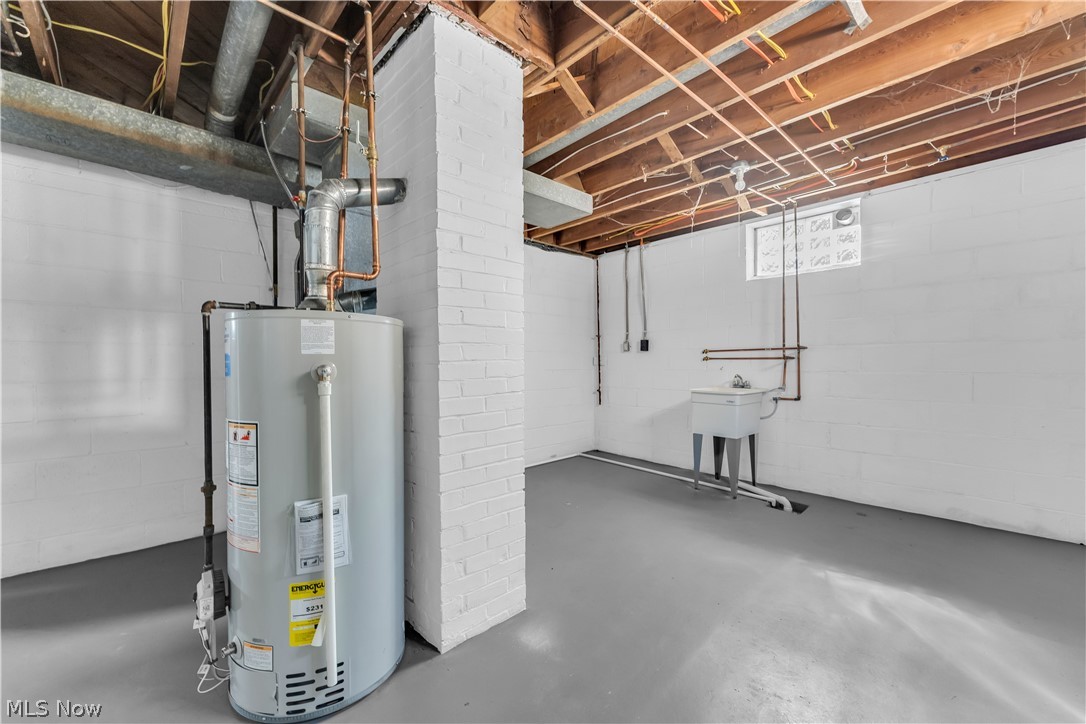 4322 Roadoan Road Brooklyn, OH 44144 - Photo 27 of 27 Basement featuring brick wall and gas water heater