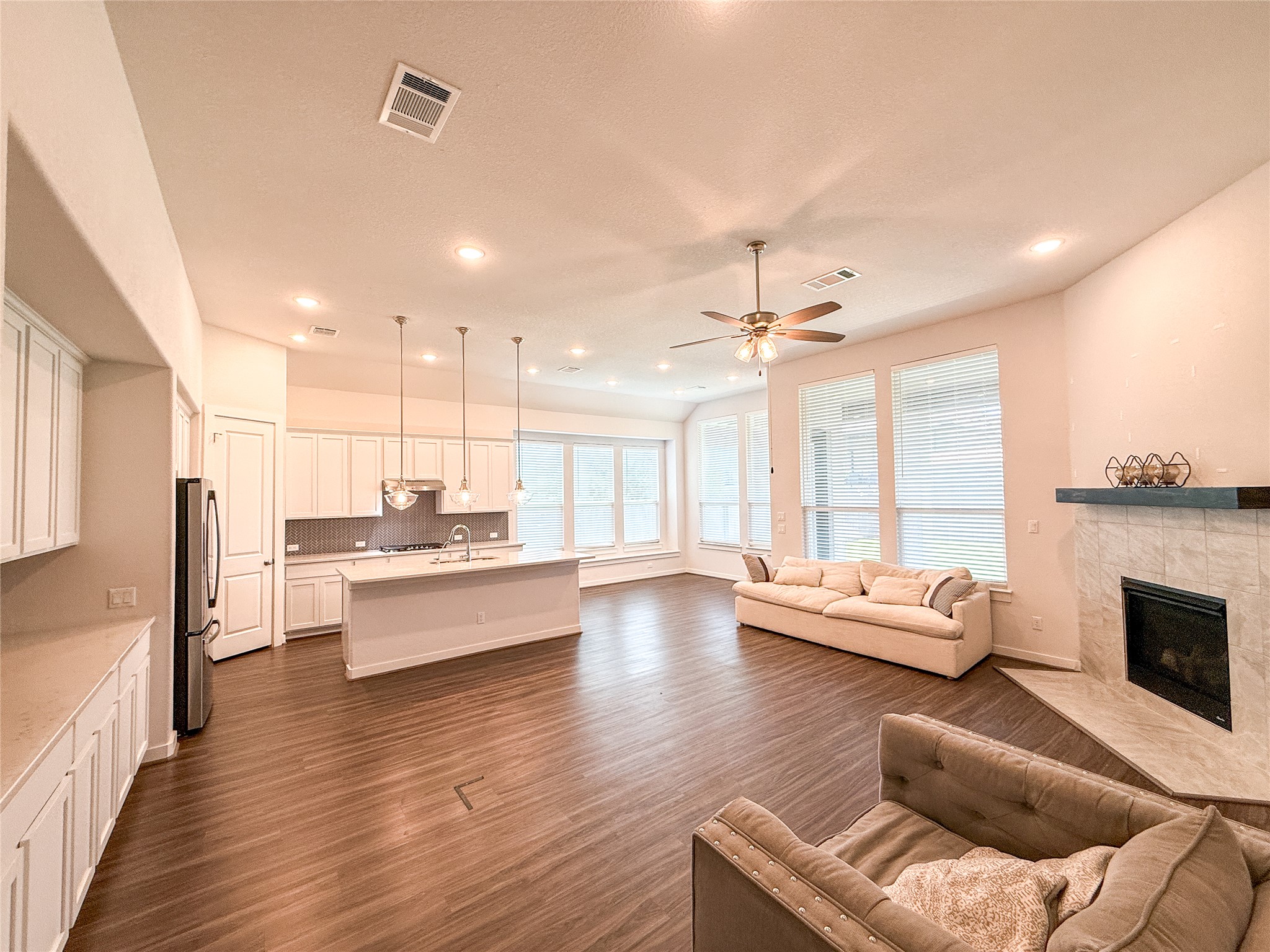 249 Heartleaf Road San Marcos, TX 78666 - Photo 38 of 38 An open floorplan seamlessly connects the well-lit kitchen and inviting living area, perfect for entertaining.
