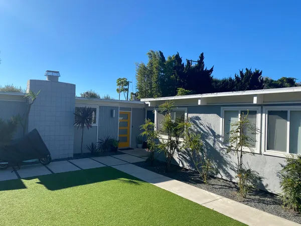 a view of a house with backyard stove and sitting area