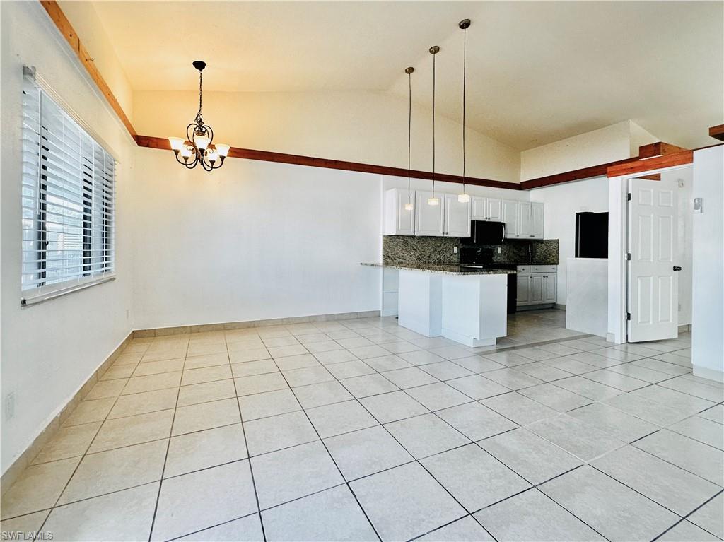 826 Wiggins Pass Road, Unit 307 Naples, FL 34110 - Photo 4 of 17 a view of a kitchen with a sink and a stove top oven