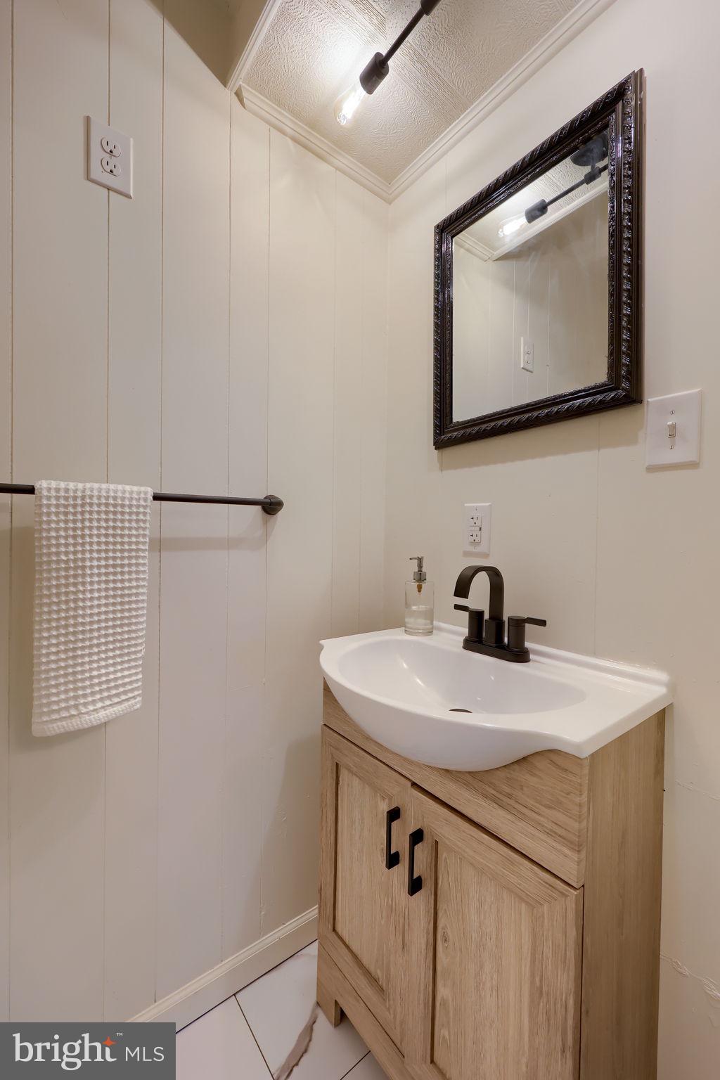 244 South 5th Street Columbia, PA 17512 - Photo 16 of 45 a bathroom with a sink and a mirror