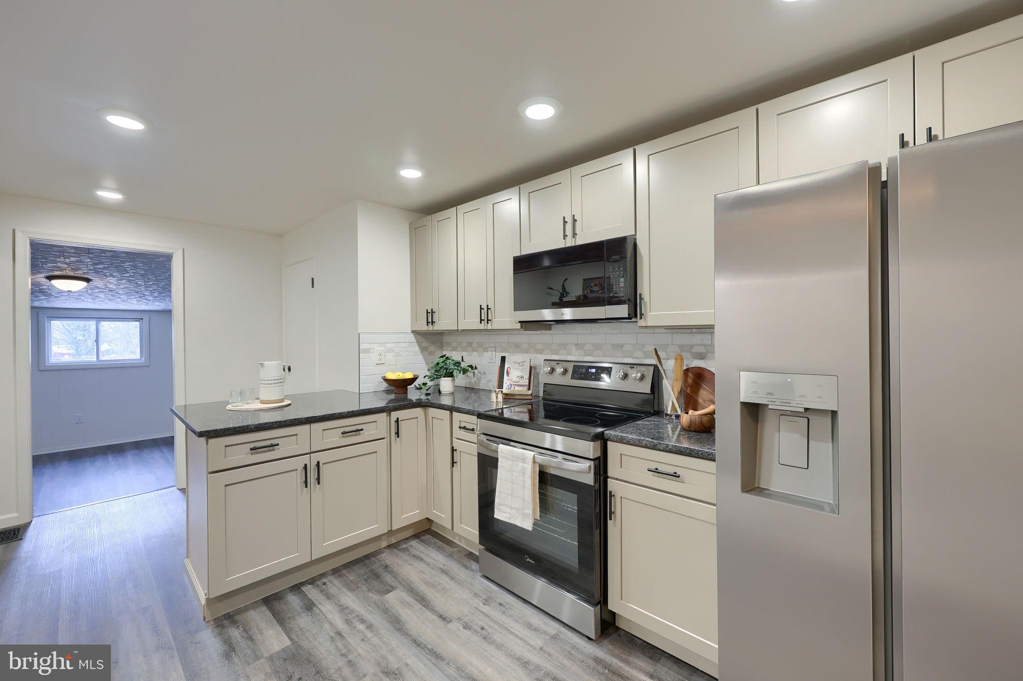 244 South 5th Street Columbia, PA 17512 - Photo 17 of 45 a kitchen with a sink stainless steel appliances and white cabinets