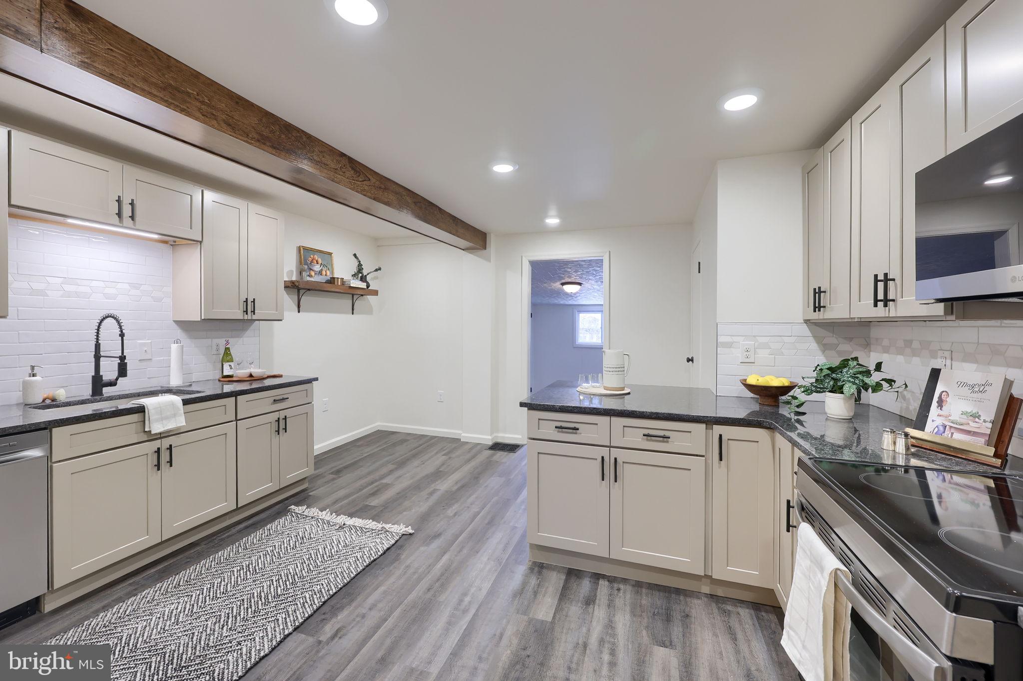 244 South 5th Street Columbia, PA 17512 - Photo 18 of 45 a kitchen with a sink stove top oven and cabinets