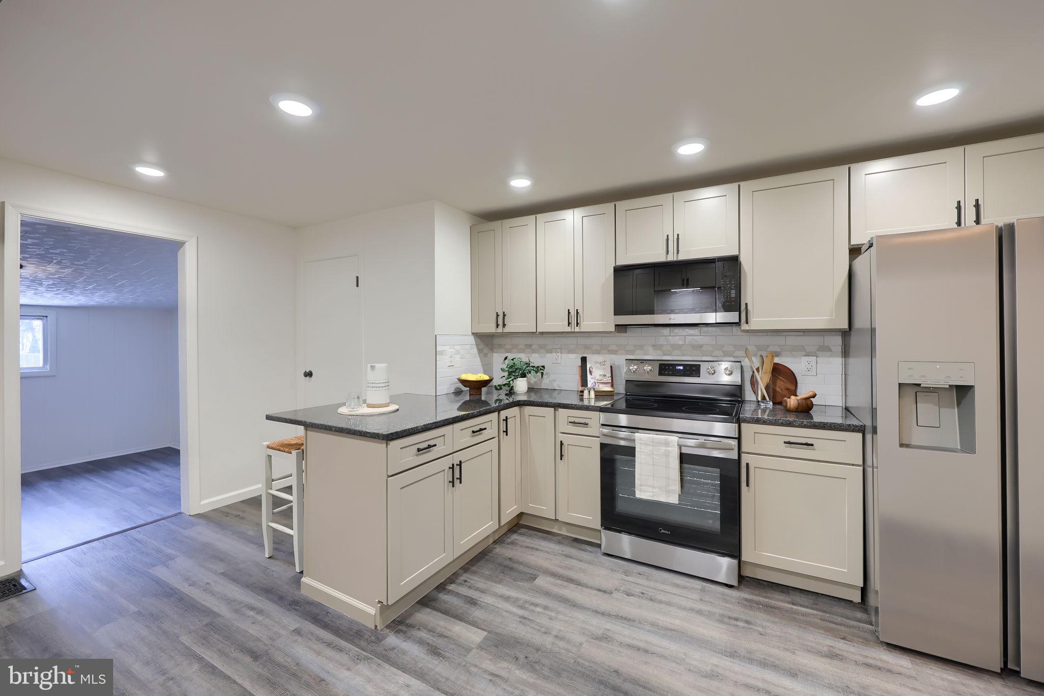 244 South 5th Street Columbia, PA 17512 - Photo 20 of 45 a kitchen with stainless steel appliances granite countertop a stove top oven a refrigerator and a sink