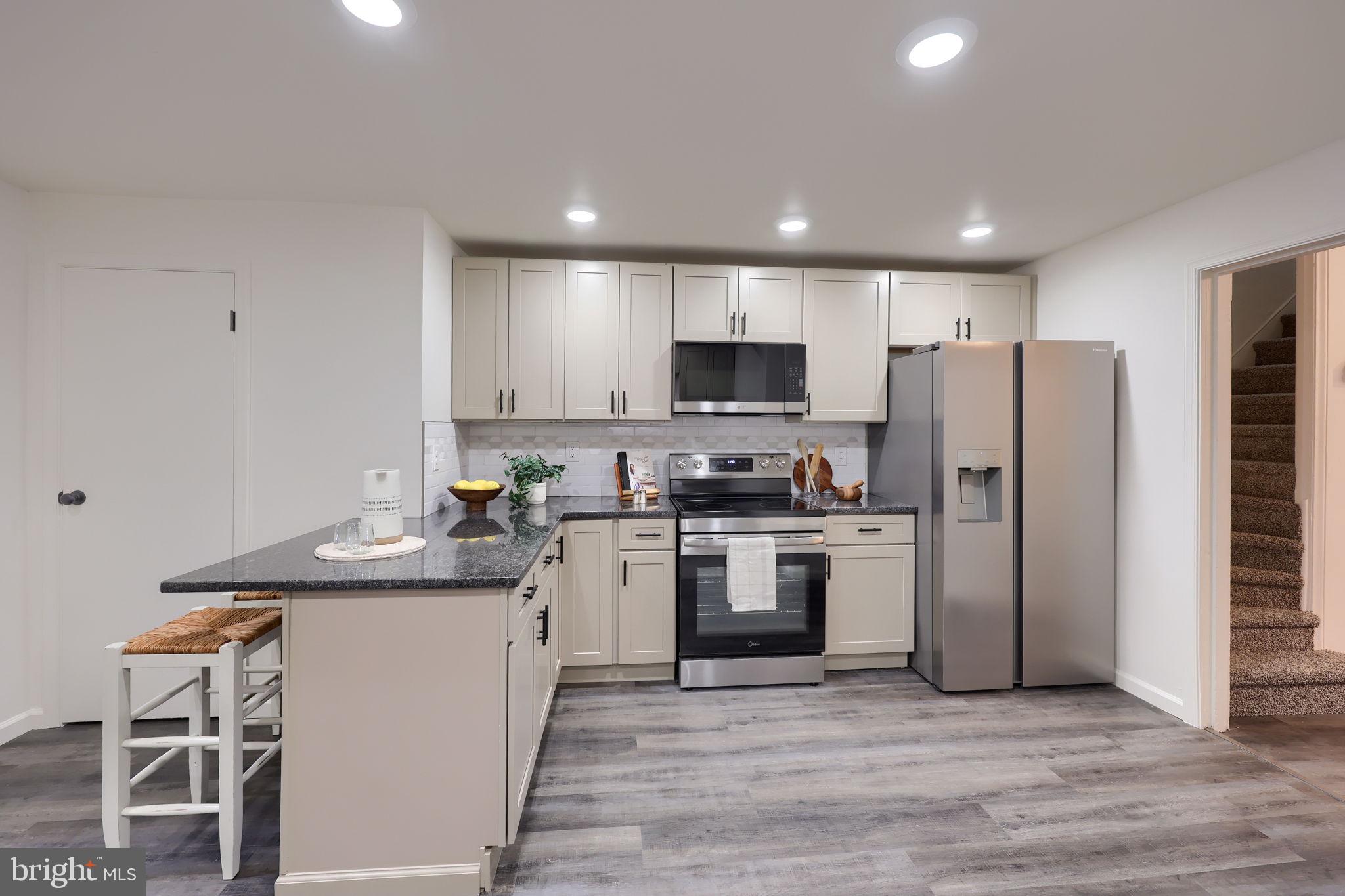 244 South 5th Street Columbia, PA 17512 - Photo 21 of 45 a kitchen with a sink stainless steel appliances and white cabinets