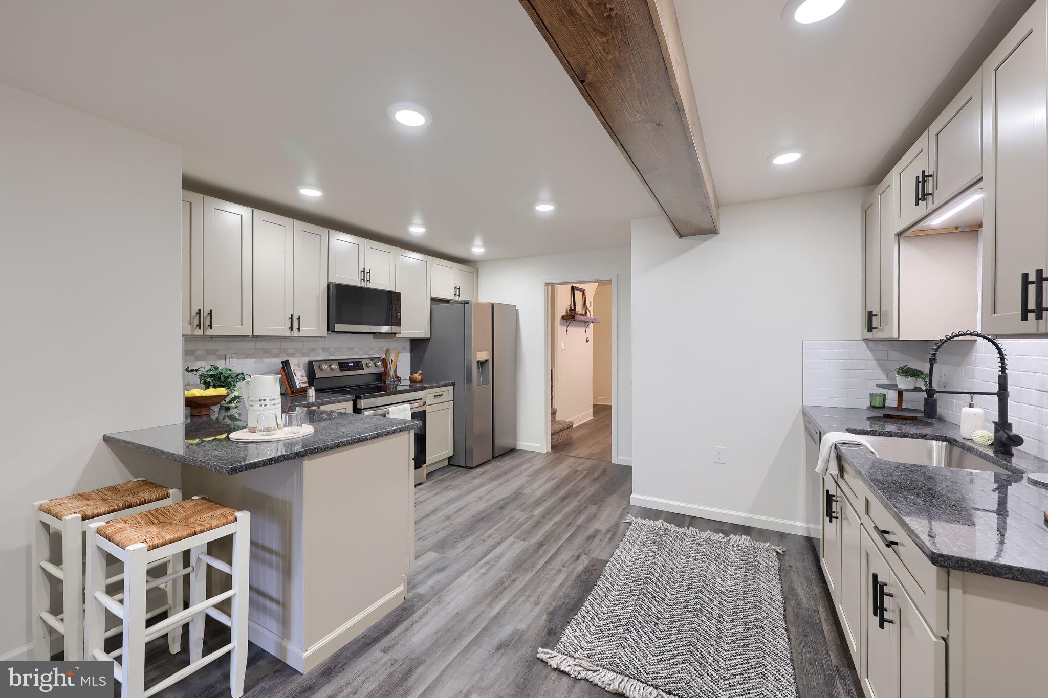244 South 5th Street Columbia, PA 17512 - Photo 22 of 45 a kitchen with stainless steel appliances granite countertop a sink stove and refrigerator