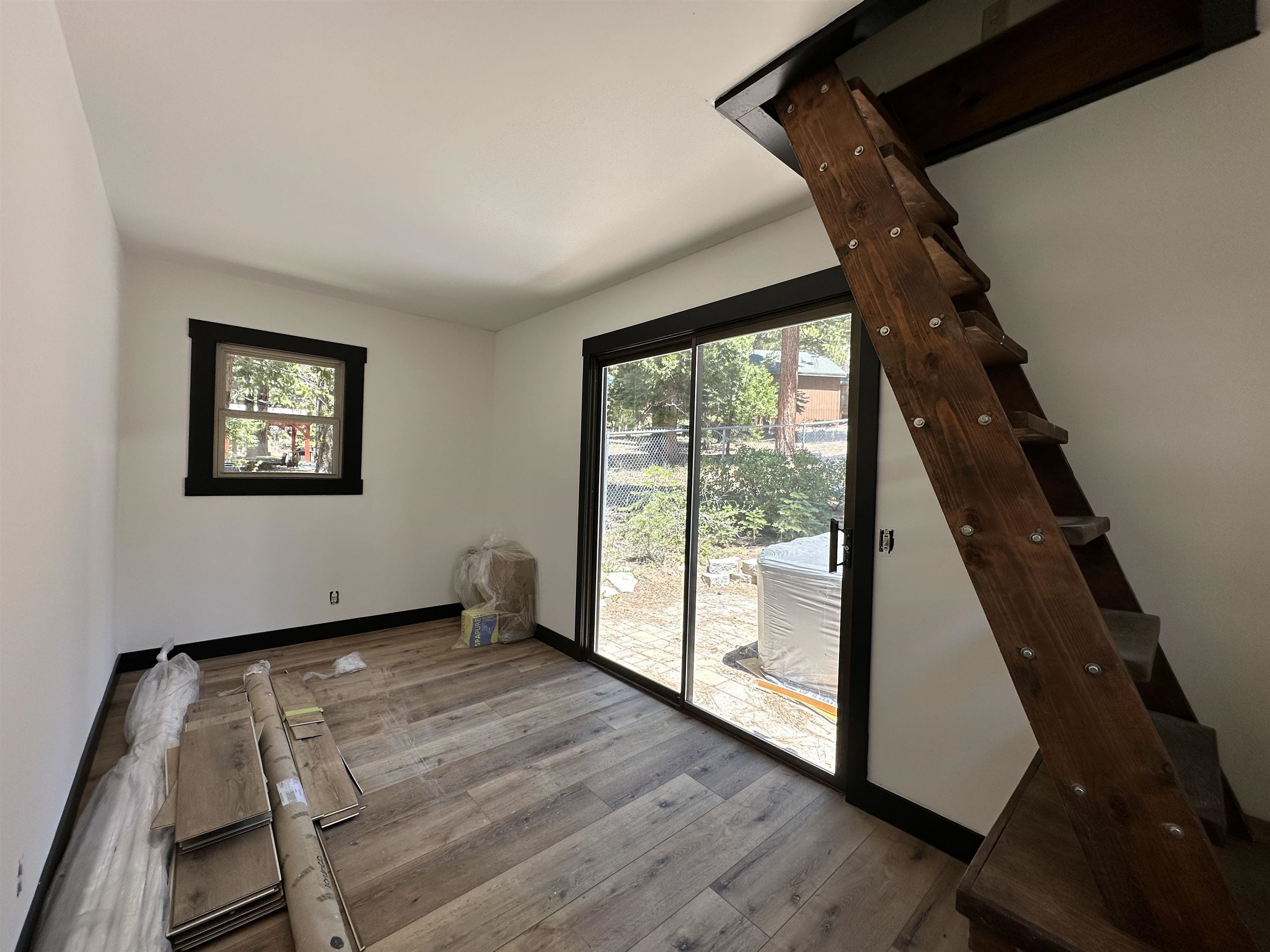 650 Chipmunk Street Kings Beach, CA 96143 - Photo 6 of 8 a view of an empty room with wooden floor and windows